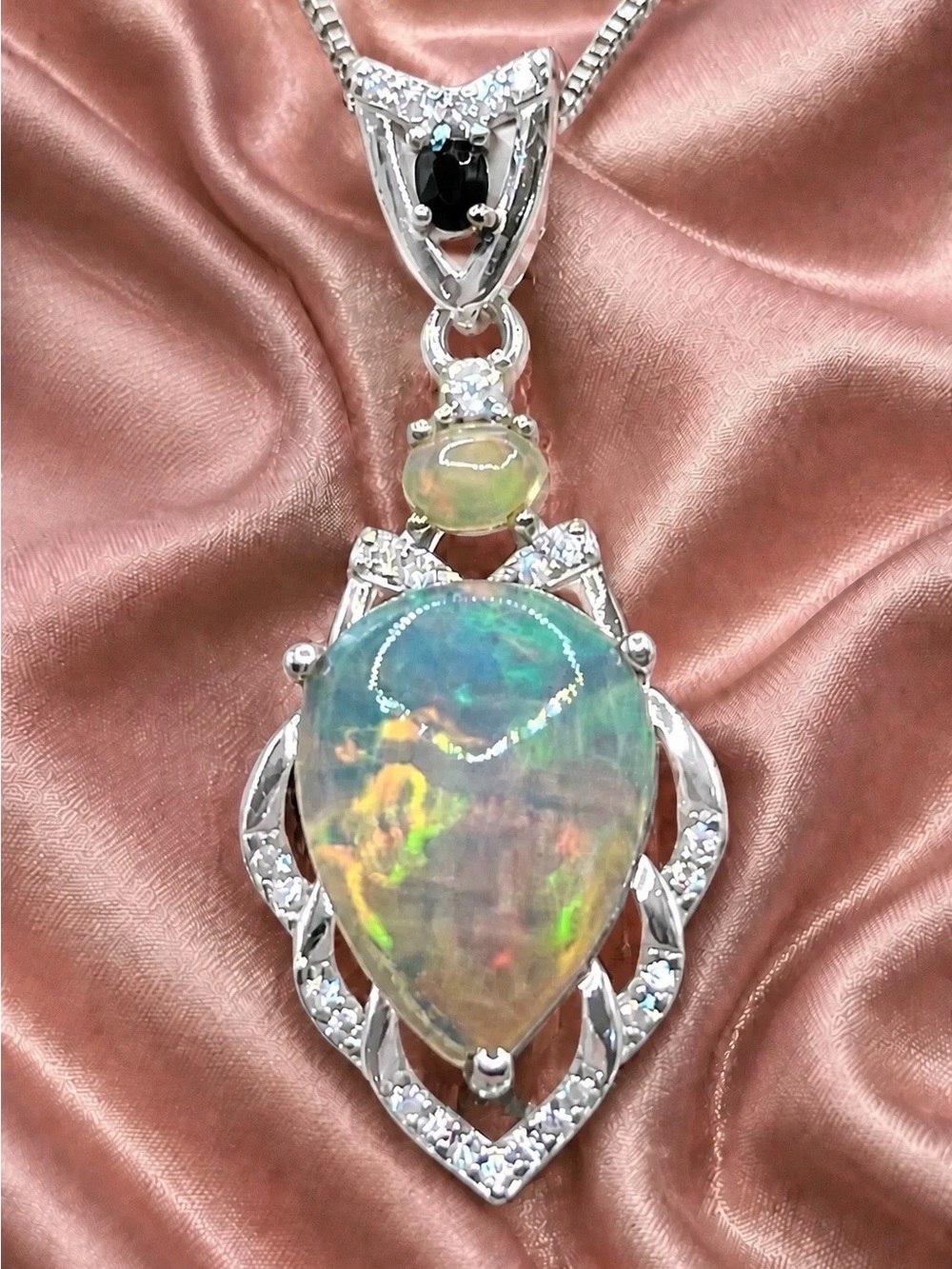 Stunning 3ctw Opal Cabachon set in rhodium over 925 S.Silver. Moissanite accents